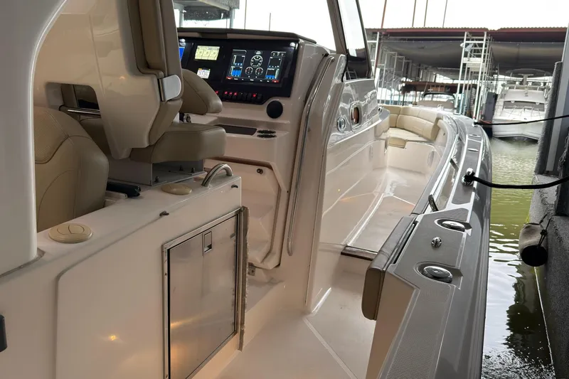  Yacht Photos Pics 2019 Pursuit S 408 Sport boat interior with advanced dashboard and seating.