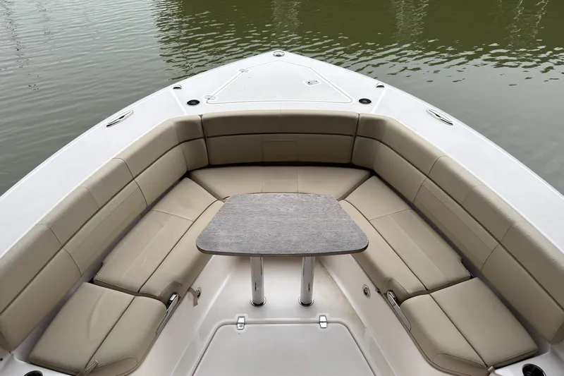  Yacht Photos Pics 2019 Pursuit S 408 Sport boat with beige seating and table on calm water.