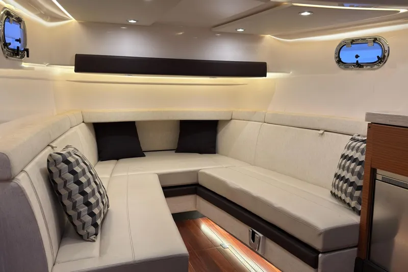  Yacht Photos Pics Luxurious interior of 2019 Pursuit S 408 Sport boat with plush seating and ambient lighting.