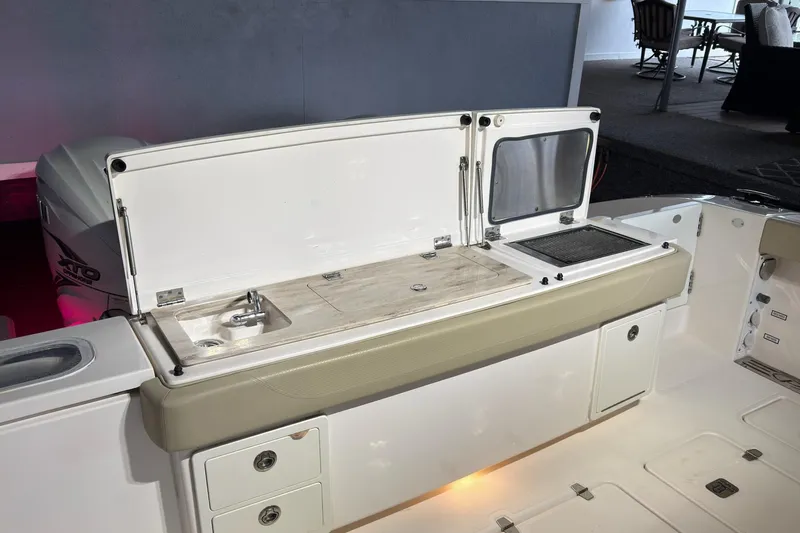  Yacht Photos Pics 2019 Pursuit S 408 Sport boat with open storage and sink area.