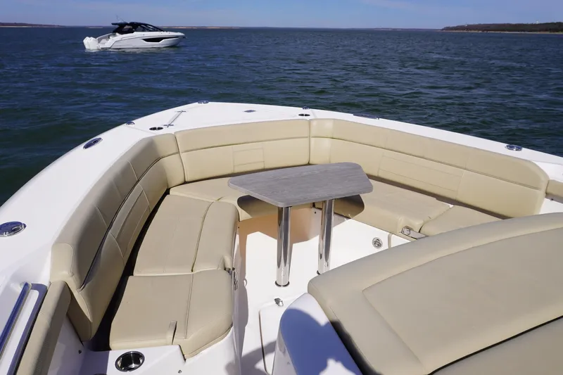  Yacht Photos Pics 2019 Pursuit S 408 Sport boat with spacious seating and table on open water.