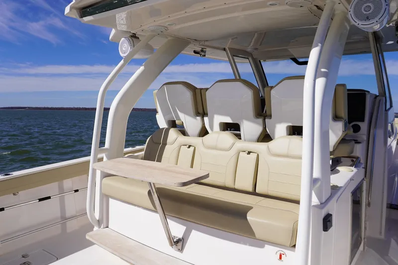  Yacht Photos Pics 2019 Pursuit S 408 Sport boat interior with seating and table on open water.