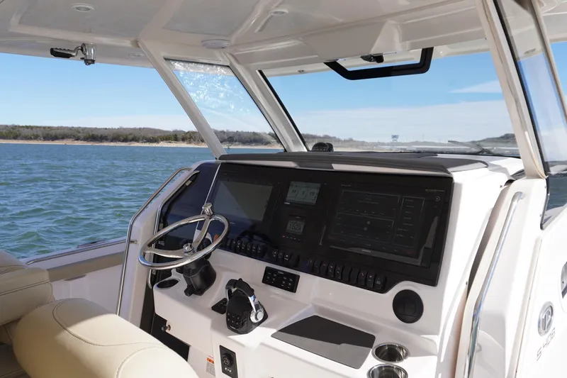  Yacht Photos Pics 2019 Pursuit S 408 Sport boat cockpit with advanced navigation system on open water.