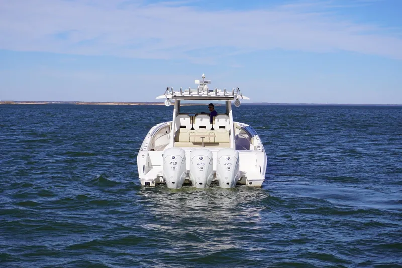  Yacht Photos Pics 2019 Pursuit S 408 Sport boat on open water, featuring triple outboard engines.