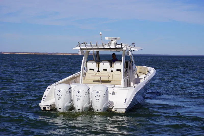  Yacht Photos Pics 2019 Pursuit S 408 Sport boat with triple engines cruising on open water.