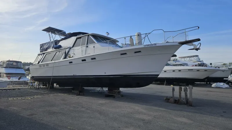  Yacht Photos Pics 1988 Bayliner 4550/4558 Pilothouse yacht on dry dock, clear sky background.