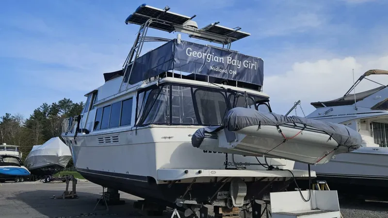  Yacht Photos Pics 1988 Bayliner 4550/4558 Pilothouse yacht on land with inflatable boat, "Georgian Bay Girl" banner.