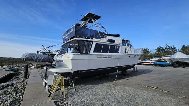  Yacht Photos Pics 1988 Bayliner 4550/4558 Pilothouse yacht on dry dock, clear sky background.