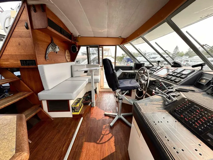  Yacht Photos Pics 1988 Bayliner 4550 Pilothouse interior with helm, seating, and wood accents.