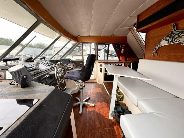  Yacht Photos Pics 1988 Bayliner 4550 Pilothouse interior with steering wheel, seating, and navigation equipment.