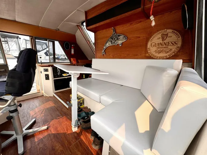  Yacht Photos Pics 1988 Bayliner 4550 Pilothouse interior with white seating, wooden accents, and nautical decor.