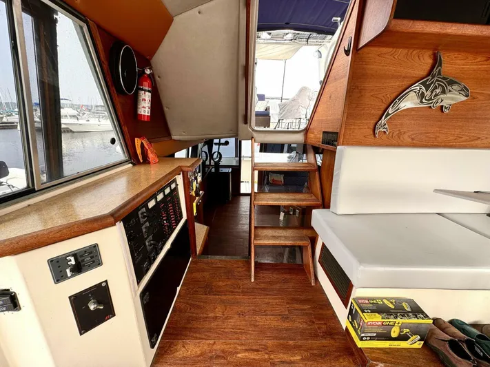  Yacht Photos Pics 1988 Bayliner 4550 Pilothouse interior with wood accents, seating, and control panel.