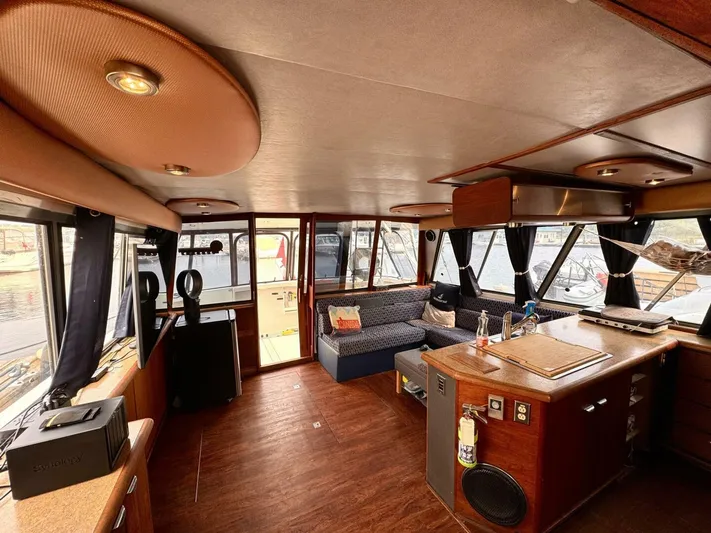  Yacht Photos Pics Interior of 1988 Bayliner 4550 Pilothouse with wood flooring and cozy seating area.