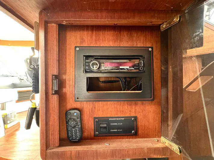  Yacht Photos Pics 1988 Bayliner 4550 Pilothouse stereo system with remote and control panel in wooden cabinet.