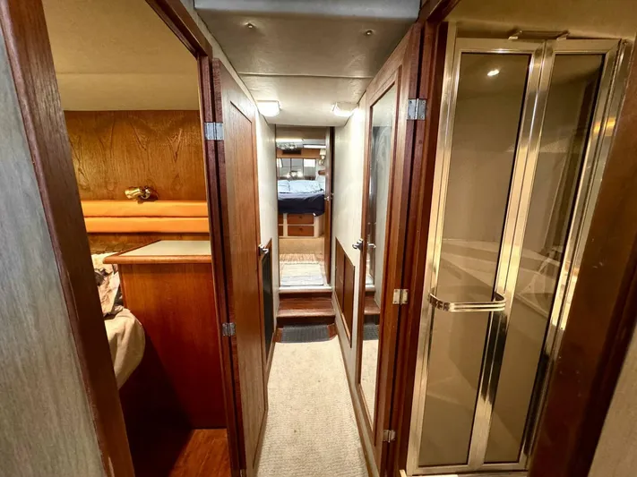  Yacht Photos Pics 1988 Bayliner 4550 Pilothouse interior hallway with wood paneling and glass shower door.