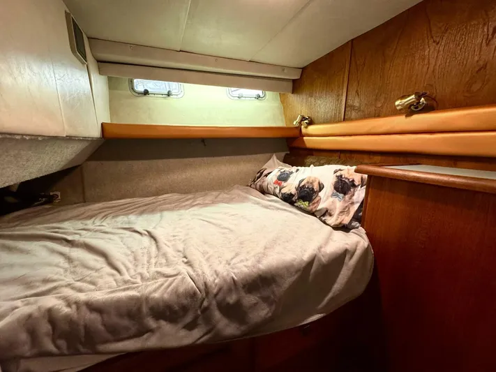  Yacht Photos Pics 1988 Bayliner 4550 Pilothouse cabin with cozy bed and wooden interior.