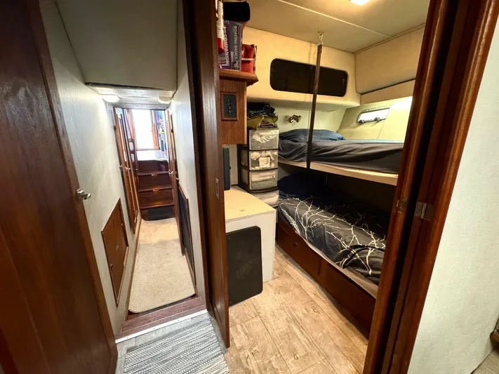  Yacht Photos Pics 1988 Bayliner 4550 Pilothouse interior with cozy bunk beds and wooden flooring.