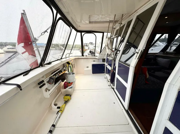  Yacht Photos Pics 1988 Bayliner 4550/4558 Pilothouse yacht interior with fishing gear and Canadian flag.