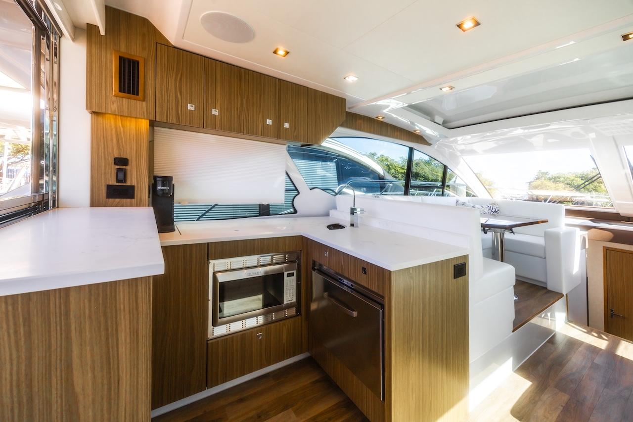 Luxurious interior of 2024 Cruisers Yachts 50 Cantius with modern kitchen design.