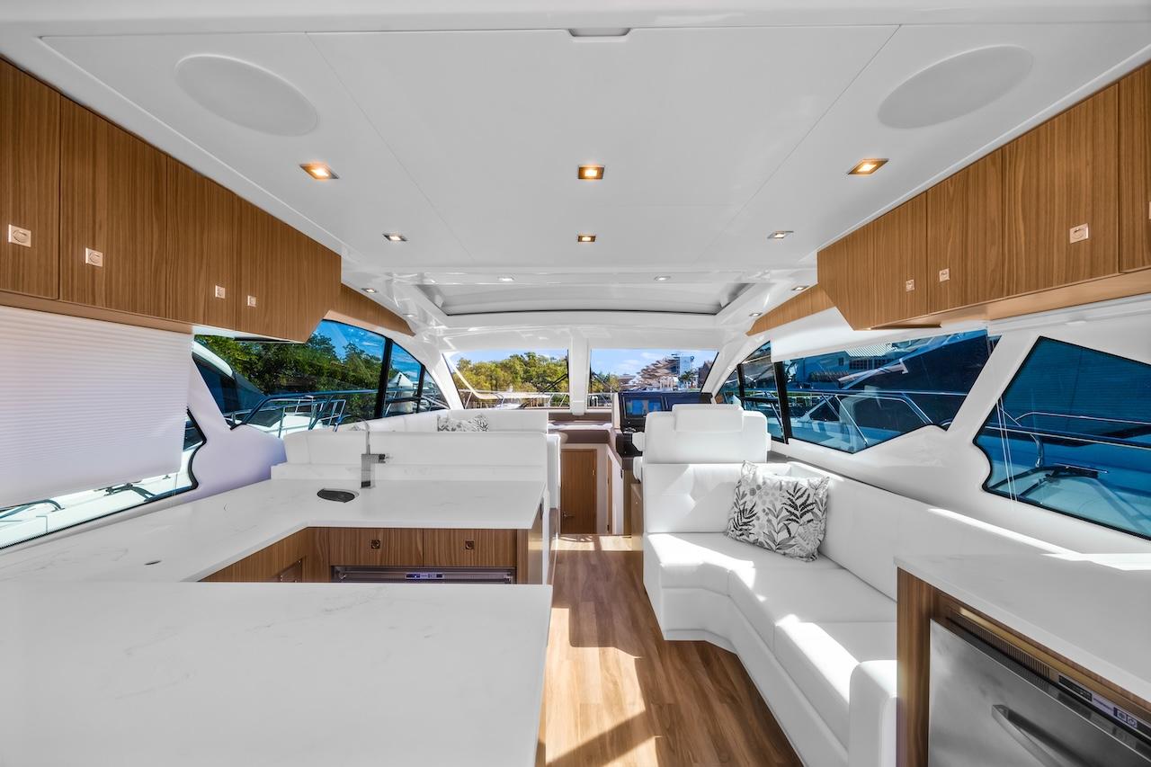 Luxurious interior of 2024 Cruisers Yachts 50 Cantius with modern design and spacious seating.