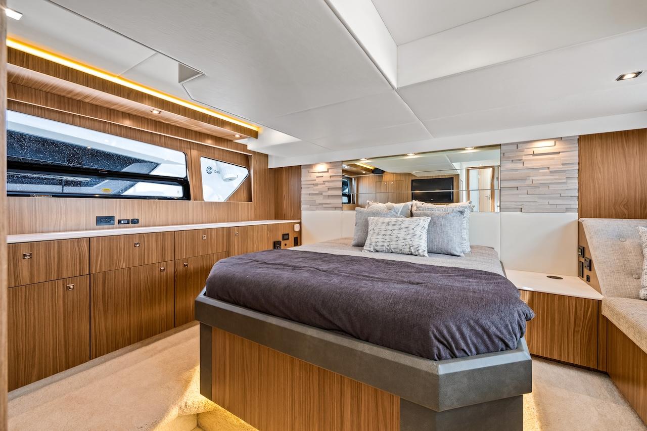 Luxurious 2024 Cruisers Yachts 50 Cantius bedroom with modern wood finishes and elegant decor.
