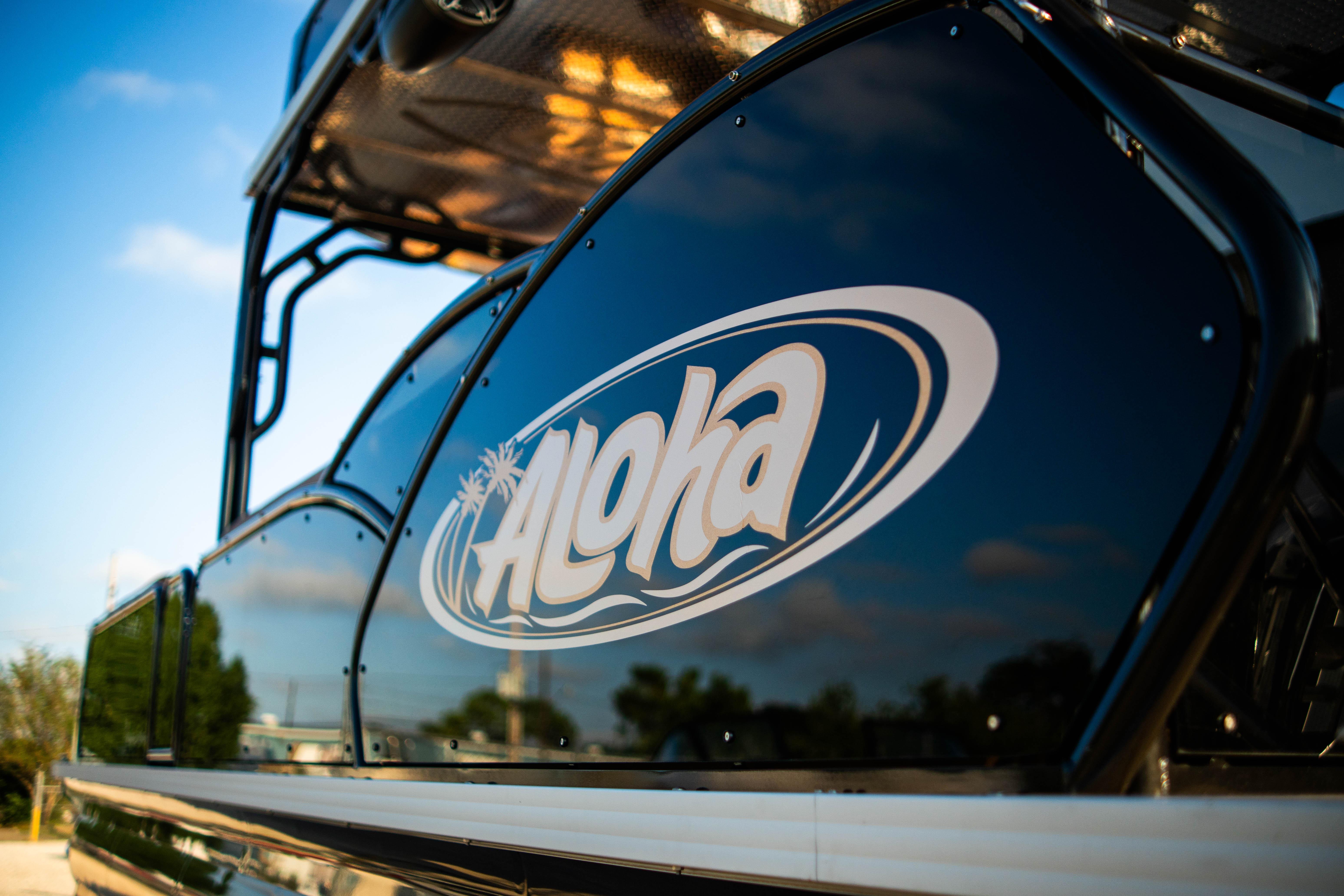 2026 Aloha Paradise 300 Sundeck boat with logo, sunny day background.