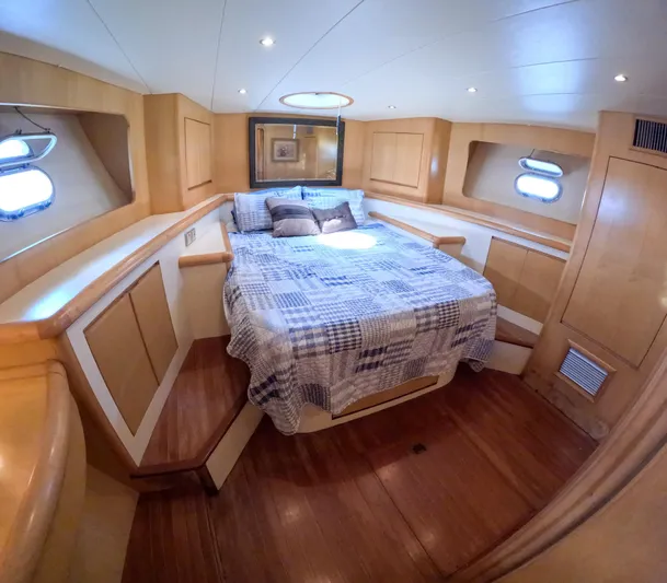 Antiquity Yacht Photos Pics 1998 TransWorld Cruiser yacht bedroom with wooden interior and double bed.