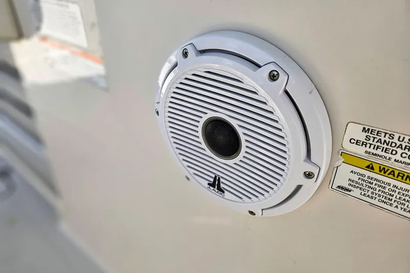 Buddy Yacht Photos Pics White speaker on 2013 Sailfish 290 CC boat with safety warning label.