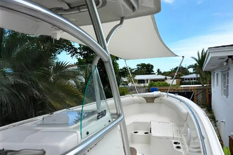 Buddy Yacht Photos Pics 2013 Sailfish 290 CC boat with canopy, docked near residential area.