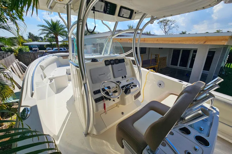 Buddy Yacht Photos Pics 2013 Sailfish 290 CC boat cockpit with steering wheel and control panel.