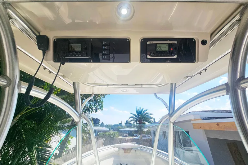 Buddy Yacht Photos Pics 2013 Sailfish 290 CC boat console with electronic controls and clear sky view.