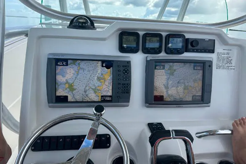 Buddy Yacht Photos Pics Dashboard of a 2013 Sailfish 290 CC boat with navigation screens and controls.