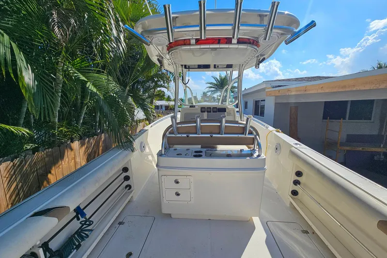 Buddy Yacht Photos Pics 2013 Sailfish 290 CC boat with center console, surrounded by lush greenery.