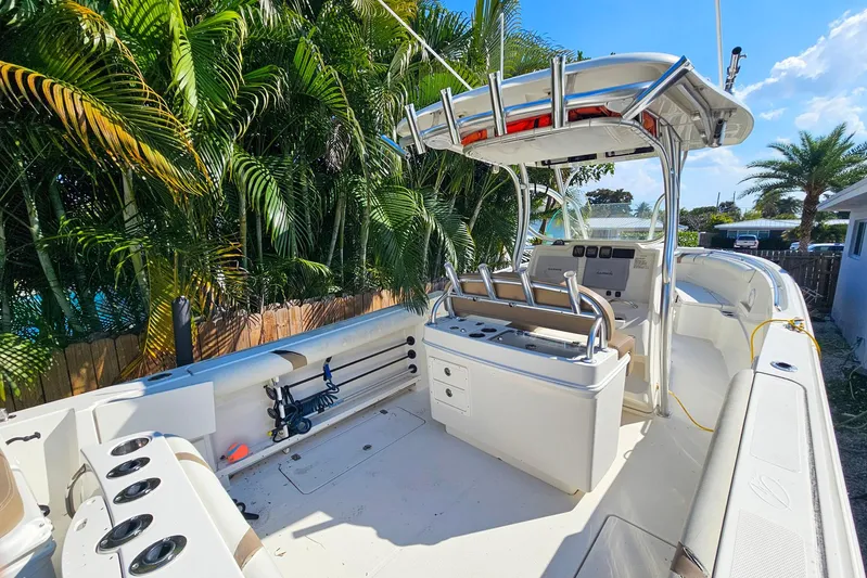 Buddy Yacht Photos Pics 2013 Sailfish 290 CC boat with center console, surrounded by lush palm trees.