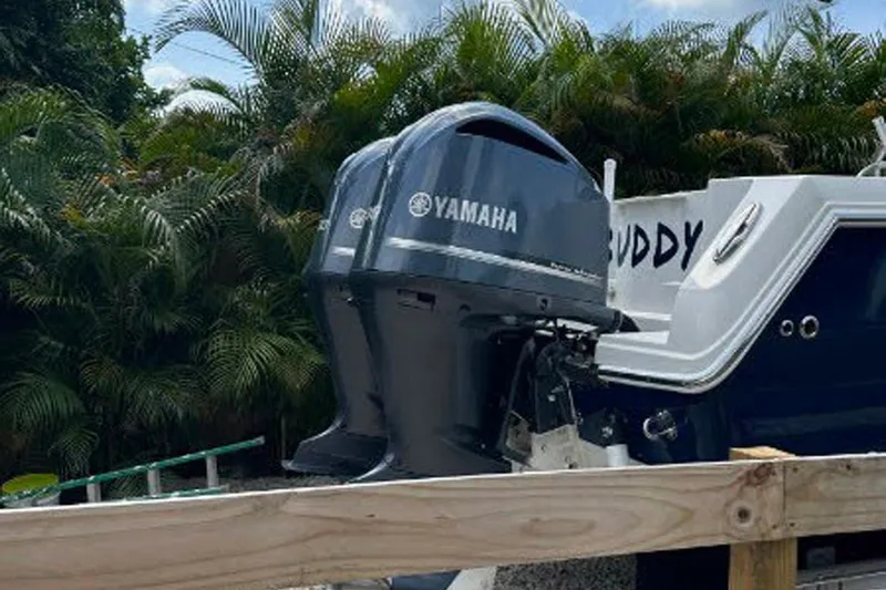 Buddy Yacht Photos Pics 2013 Sailfish 290 CC boat with Yamaha outboard motors, surrounded by lush greenery.