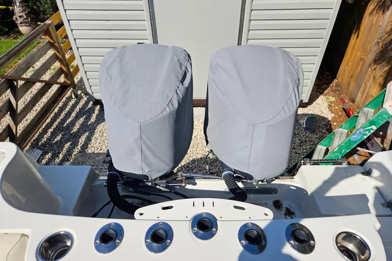 Buddy Yacht Photos Pics Covered outboard motors on a 2013 Sailfish 290 CC boat, docked outdoors.