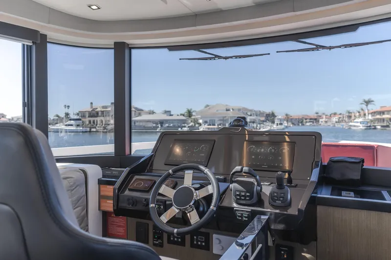 Saigon Yacht Photos Pics Interior helm of 2023 OKEAN 52 Fly yacht with modern controls and waterfront view.