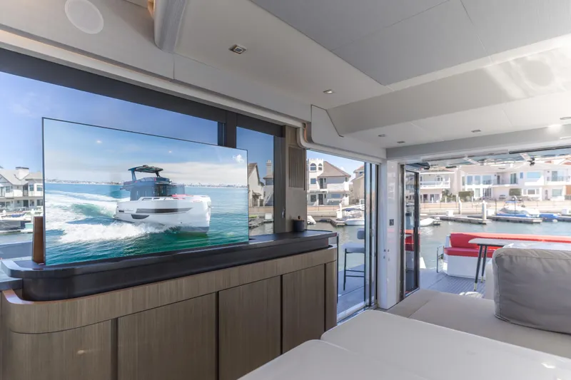 Saigon Yacht Photos Pics Luxurious interior of 2023 OKEAN 52 Fly yacht with marina view and modern TV display.