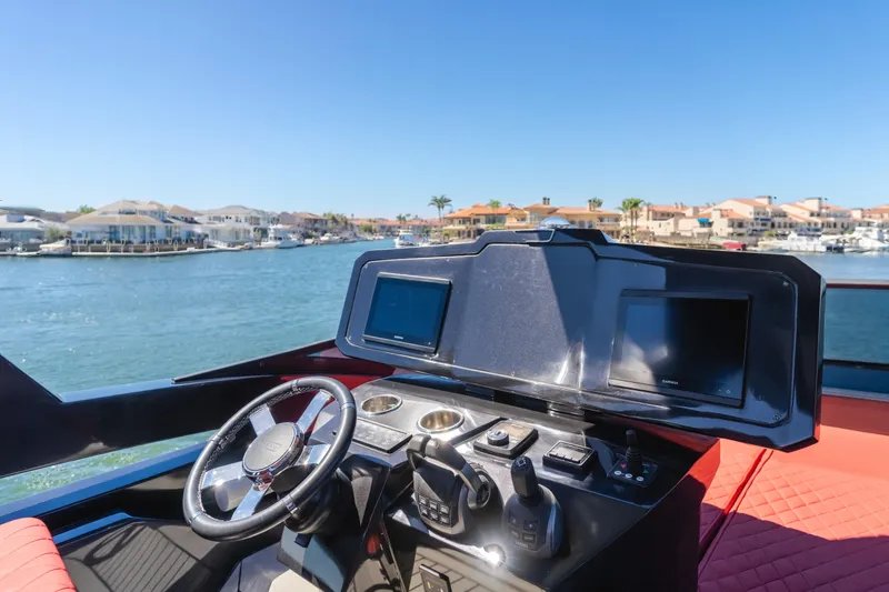 Saigon Yacht Photos Pics Helm of 2023 OKEAN 52 Fly yacht with dual screens, steering wheel, and waterfront view.