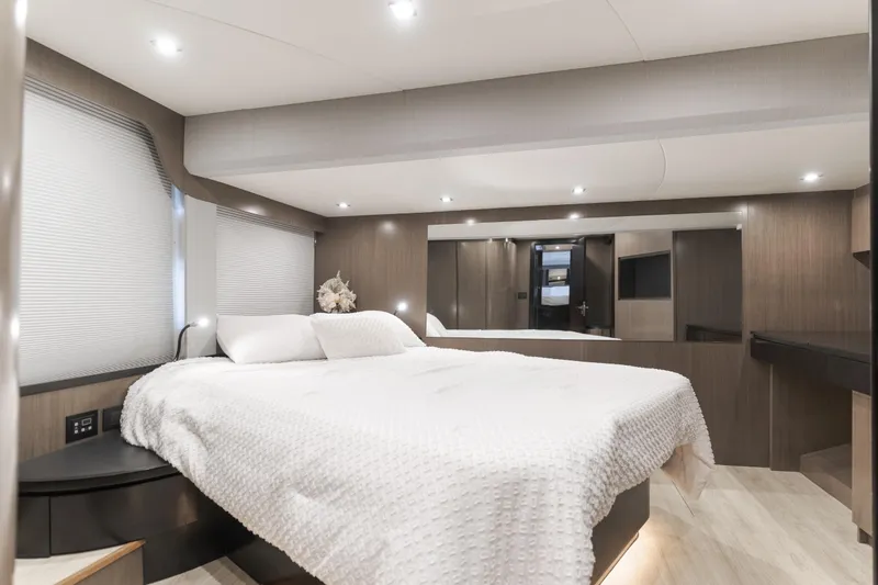 Saigon Yacht Photos Pics Luxurious bedroom interior of 2023 OKEAN 52 Fly yacht with modern design and cozy bedding.