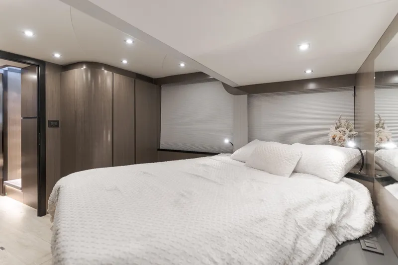 Saigon Yacht Photos Pics Luxurious bedroom interior of 2023 OKEAN 52 Fly yacht with modern design and cozy bedding.