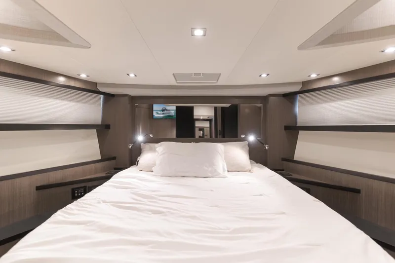 Saigon Yacht Photos Pics Luxurious bedroom interior of 2023 OKEAN 52 Fly yacht with modern lighting and cozy bedding.