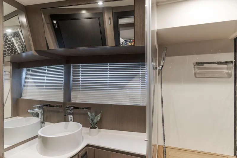 Saigon Yacht Photos Pics Modern bathroom interior on 2023 OKEAN 52 Fly yacht with sleek fixtures and blinds.