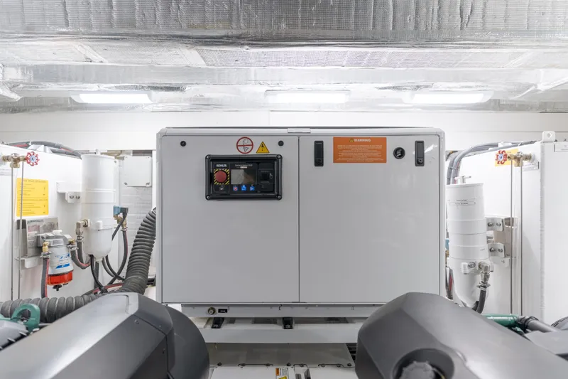 Saigon Yacht Photos Pics Engine room of 2023 OKEAN 52 Fly yacht, featuring modern equipment and controls.