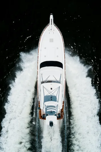 Relentless Yacht Photos Pics Aerial view of 2006 Bertram Sportfish yacht cruising through water.