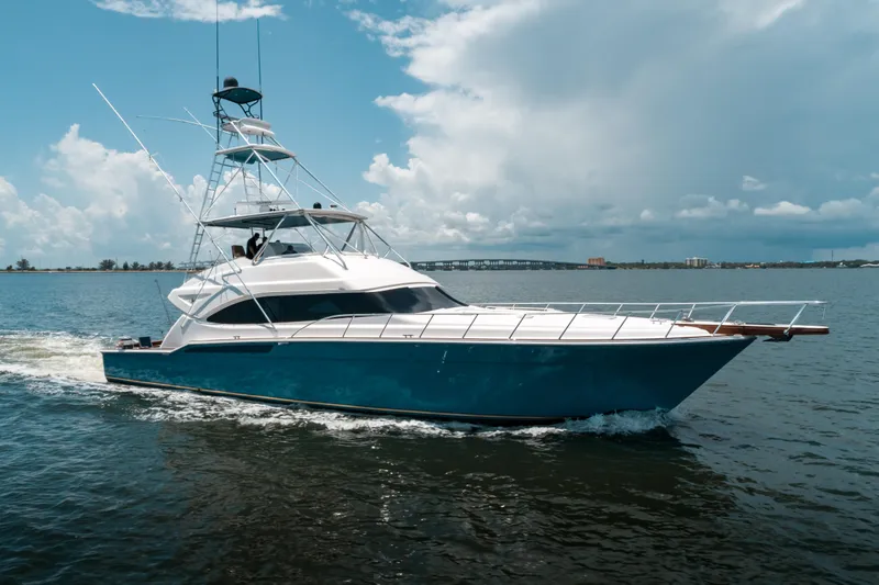 Relentless Yacht Photos Pics 2006 Bertram Sportfish yacht cruising on open water under a cloudy sky.
