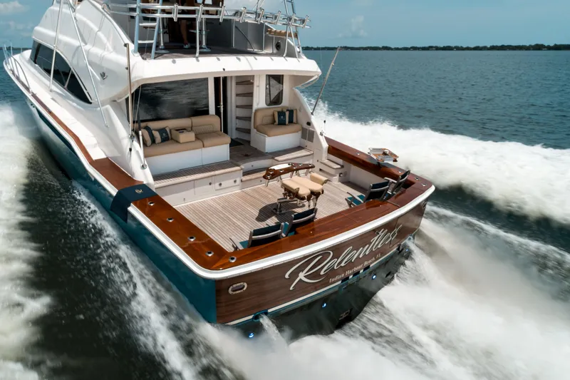 Relentless Yacht Photos Pics Bertram Sportfish 2006 yacht cruising on open water, featuring spacious deck and luxurious seating.