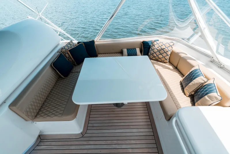 Relentless Yacht Photos Pics Luxurious seating area on 2006 Bertram Sportfish yacht with elegant cushions and table.