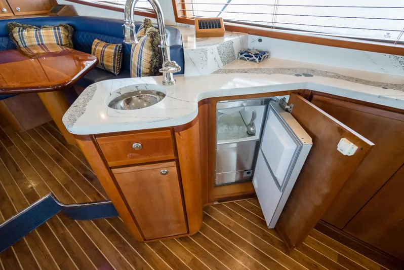 Relentless Yacht Photos Pics Luxurious 2006 Bertram Sportfish yacht interior with kitchenette and seating area.