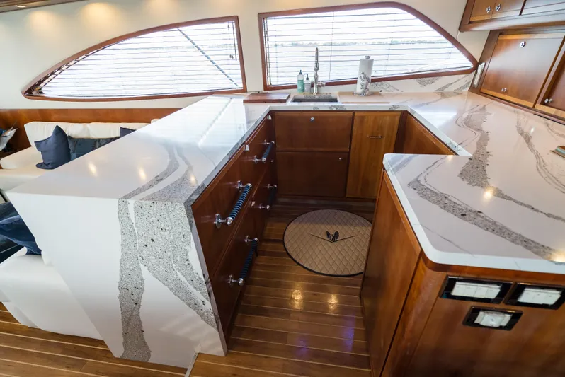 Relentless Yacht Photos Pics Luxurious 2006 Bertram Sportfish yacht interior with elegant wood cabinetry and modern countertops.